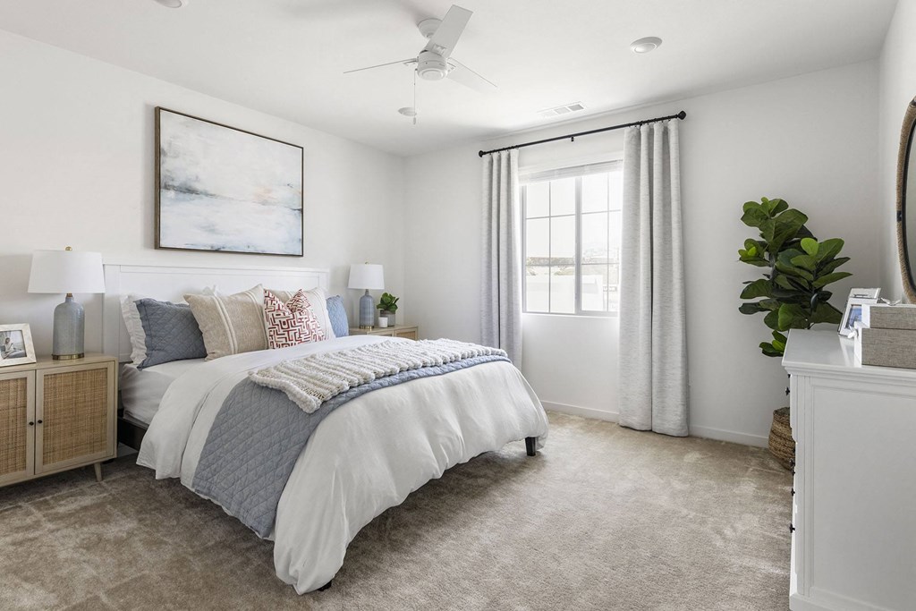 a bedroom with a bed and a ceiling fan