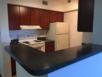 Open kitchen with appliances at Alhambra Cove, Miami Florida