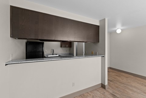 A kitchen with a black oven and a white countertop.