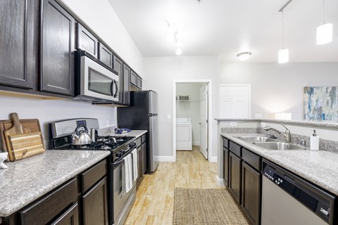 an open kitchen with granite counter tops and stainless steel appliances