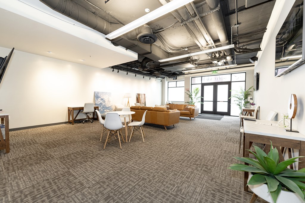 a large room with couches and chairs and a table