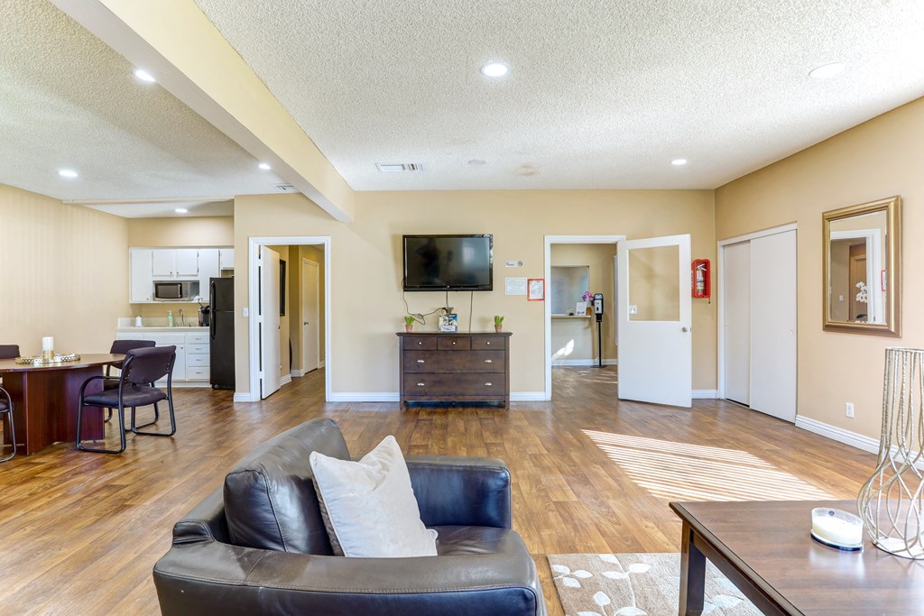 a living room with a leather couch and a tv