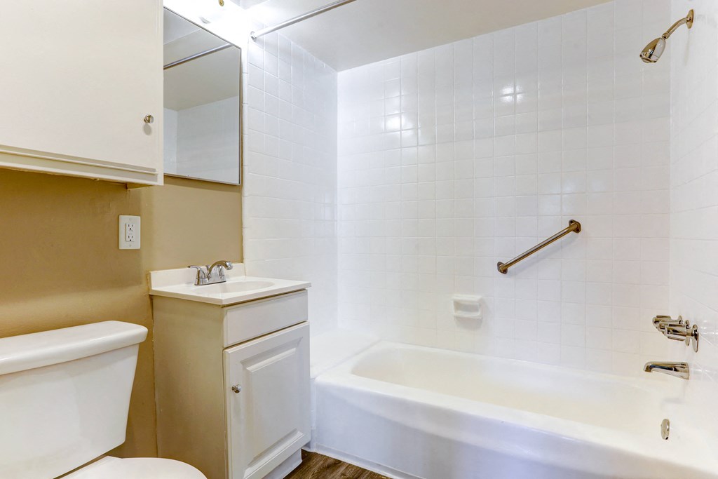 a bathroom with a sink toilet and a bath tub