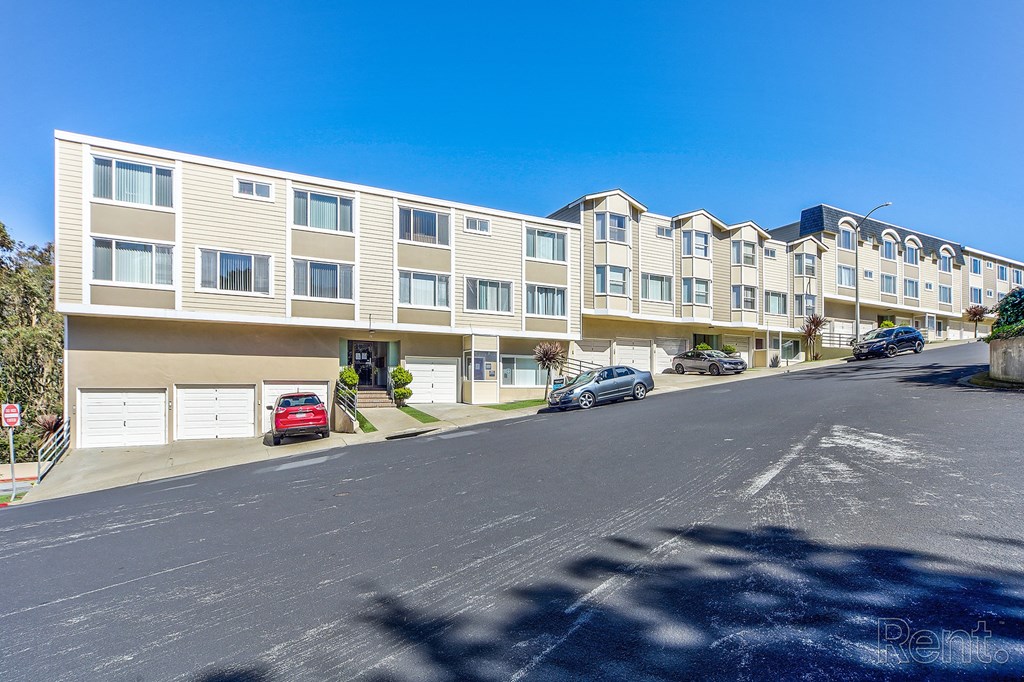 a large apartment building with a parking lot in front of it