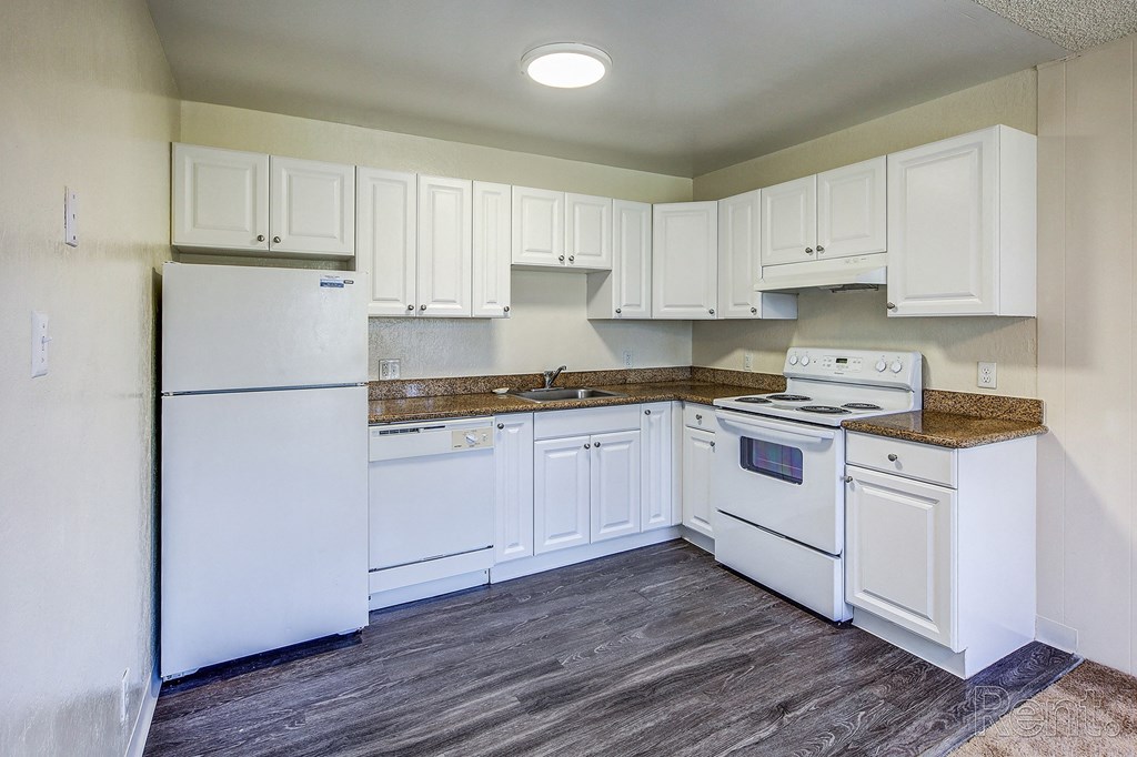 a kitchen with white cabinets and white appliances