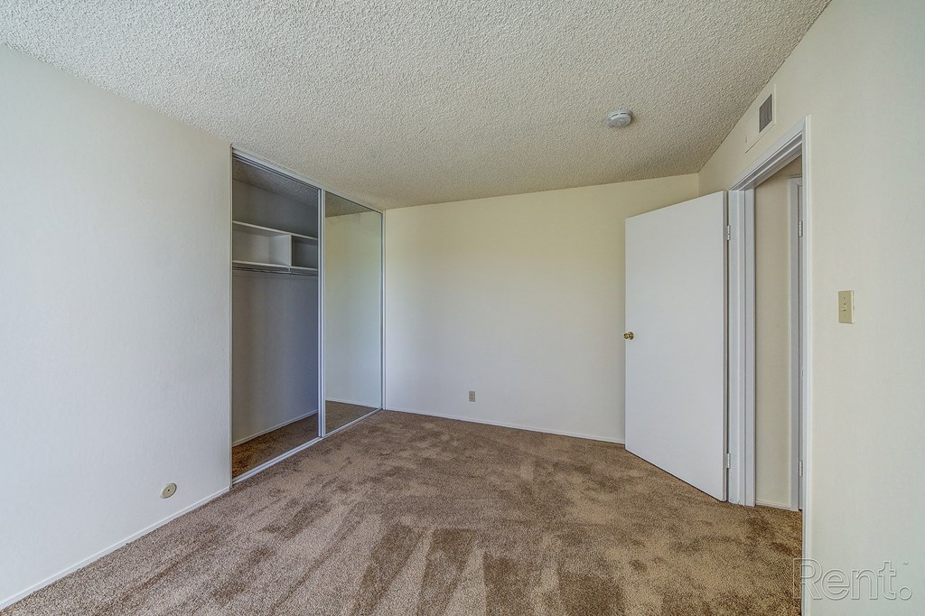 a bedroom with a closet and an open door