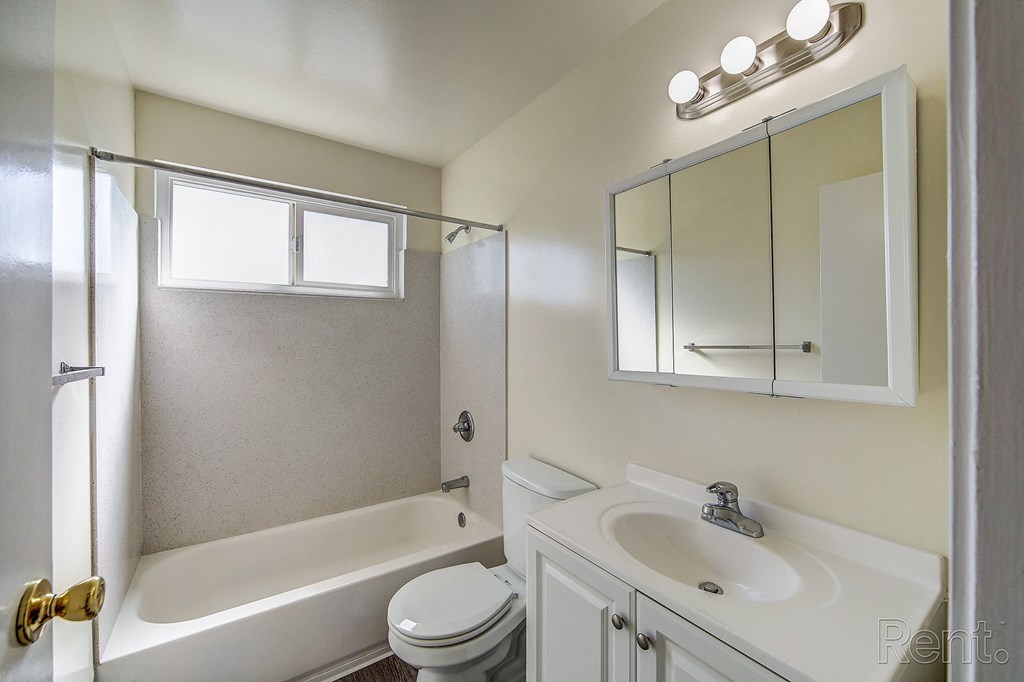 a bathroom with a bathtub and a sink