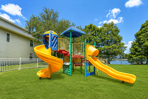 A yellow and blue slide in a playground.
