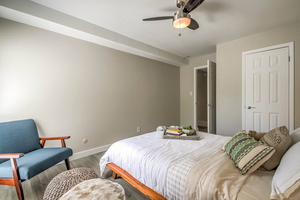a bedroom with a bed and a chair and a ceiling fan at Park Capitol, Salt Lake City