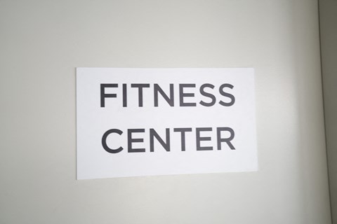 a white sign that reads fitness center on a white wall at Second & B Street, California, 94901