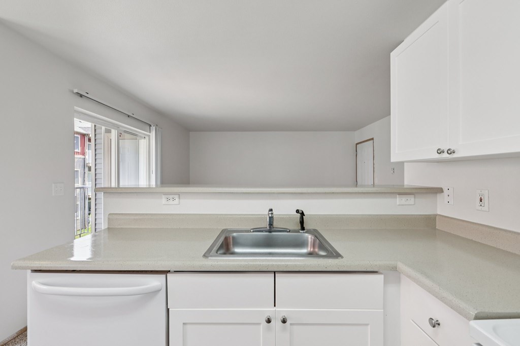 A kitchen with white cabinets and a sink.at The Timbers by Vintage, Arlington, 98223