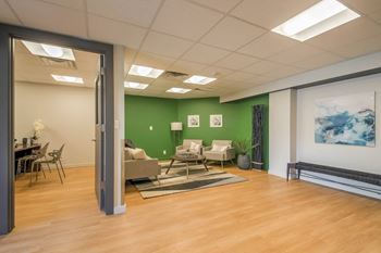 a living room with a wood floor and a green wall at Park Capitol, Salt Lake City, UT 84103
