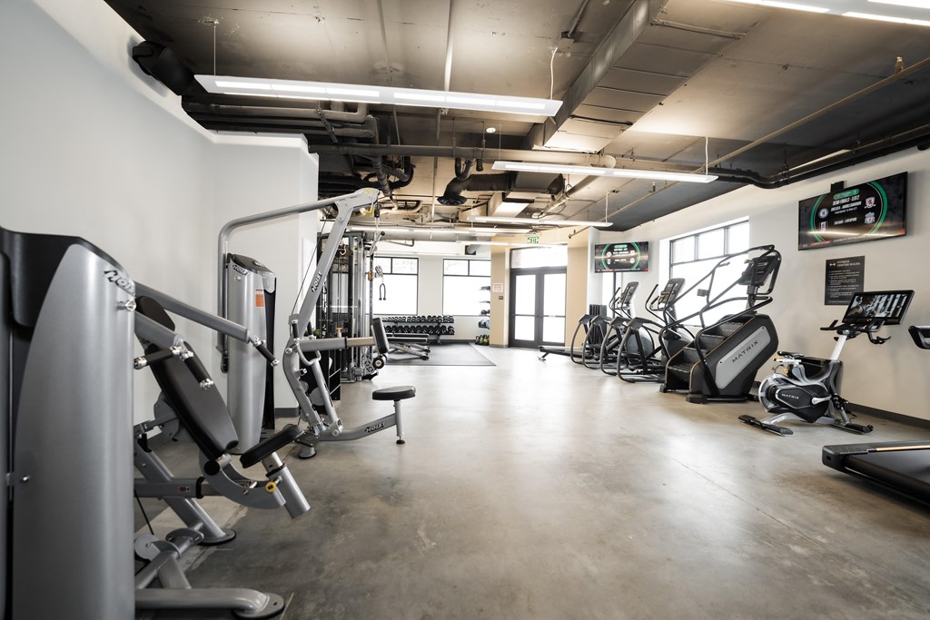 a gym with weights and other exercise equipment in a building