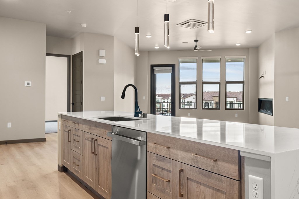 A modern kitchen with a large island and stainless steel appliances.
