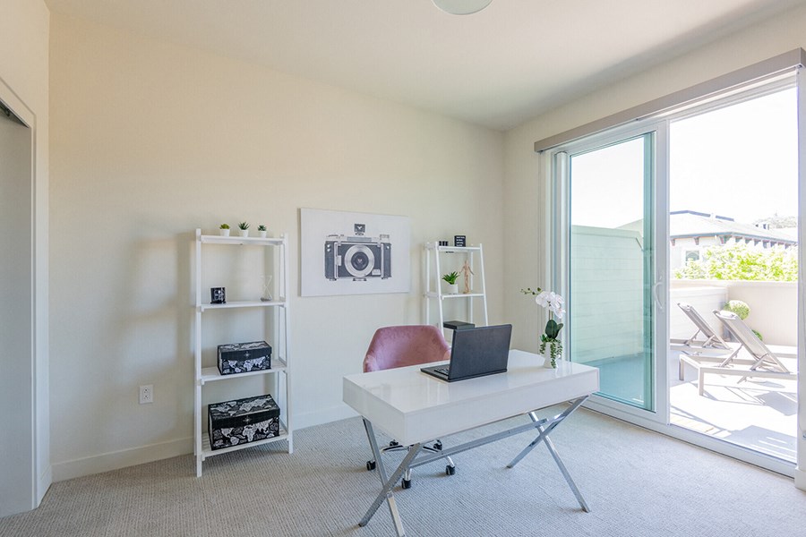 Apartments San Rafael, CA - Modern Living Room Area With High Ceilings, Carpet Flooring, Dual Pane Windows, And Access To Private Balcony.