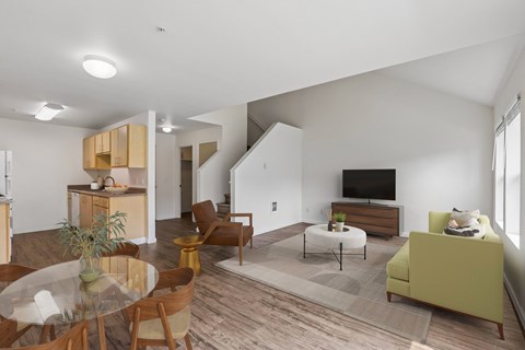 A living room with a glass table and a green couch.