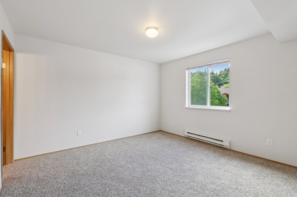 A room with a window and a carpeted floor.at The Timbers by Vintage, Arlington, WA 98223