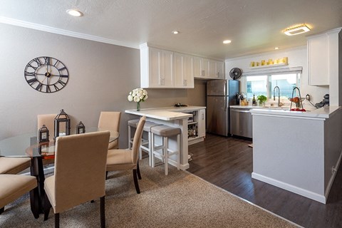 a kitchen and dining room with a table and chairs