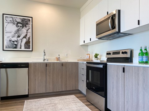 a kitchen with white cabinets and a sink and a microwave