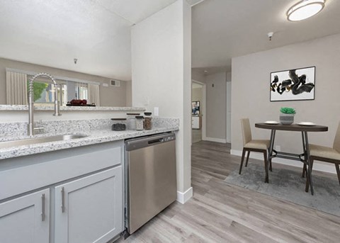 a kitchen and dining room with a sink and dishwasher