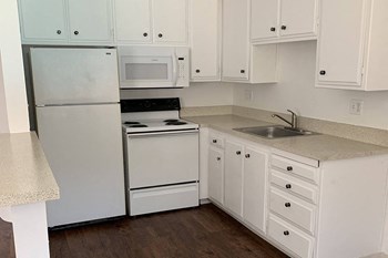 Renovated kitchen with white cabinets and appliances - Photo Gallery 2