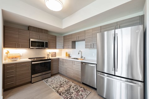a kitchen with stainless steel appliances and wooden cabinets