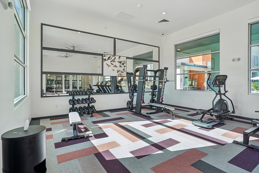 A gym with a variety of equipment including treadmills, weights, and exercise bikes.at Cottonwood Ranch, Casa Grande Arizona