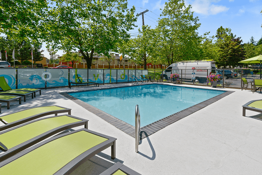 Kent WA Apartments for Rent - The BLVD - Sparkling Pool Surrounded by Lounge Seating