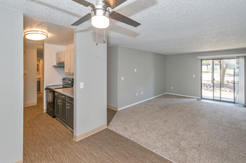 Apartments for Rent Federal Way, WA - Open-Concept Dining Room with Wood Flooring, Ceiling Fan, and Access to Living Room - Photo Gallery 5