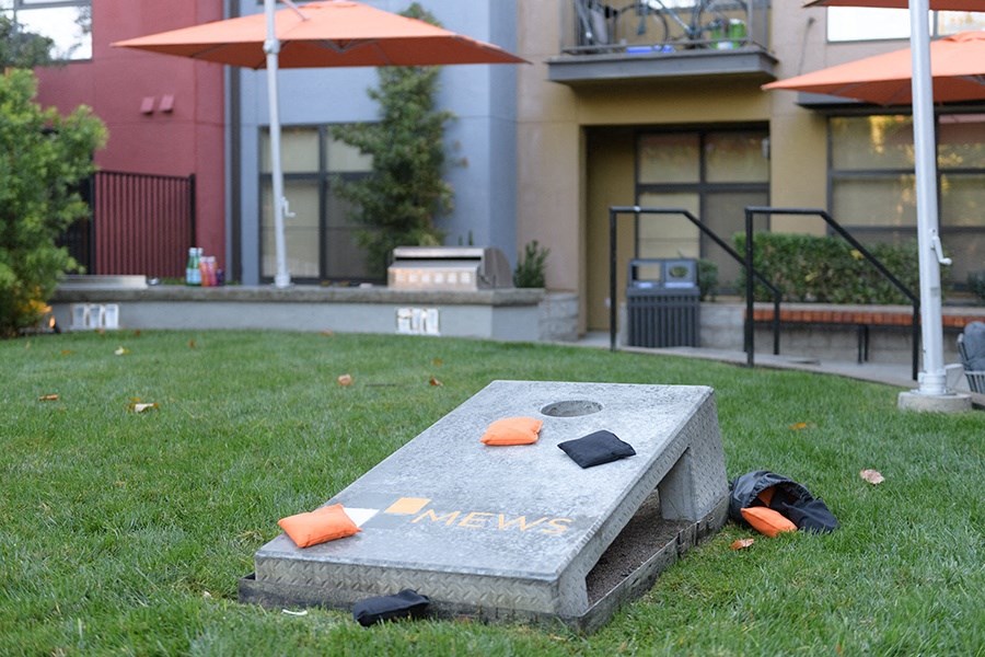 Game of corn hold on the grass near the BBQ area at FREMONT MEWS, California