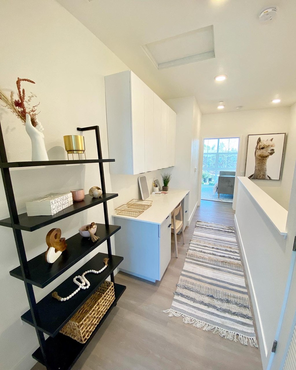 a view of a kitchen from the hallway of a house