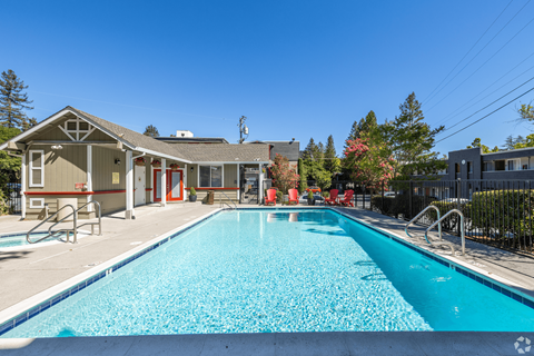A swimming pool in front of a house.