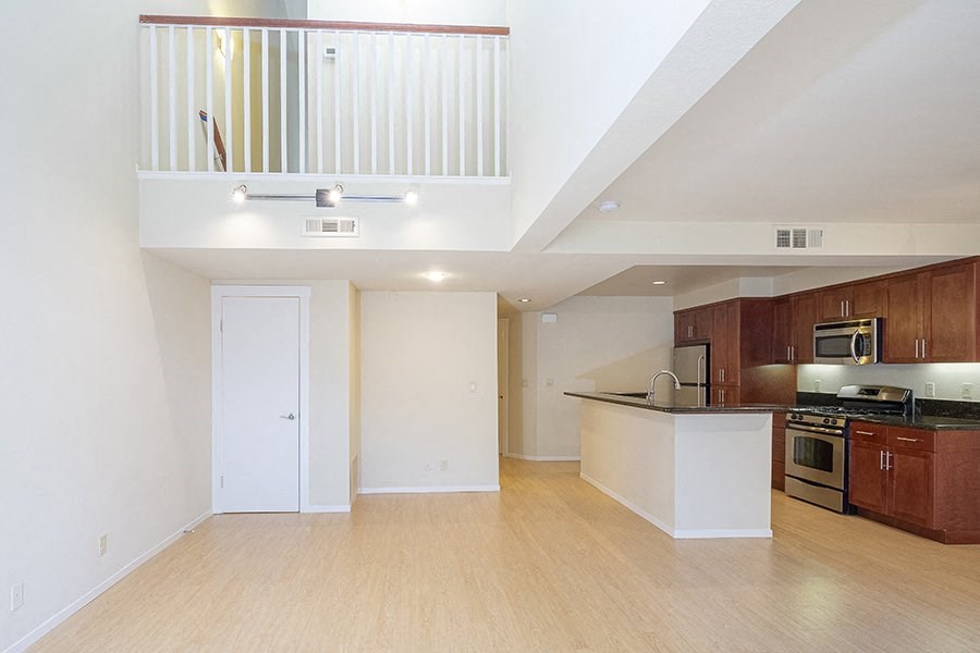 a view of the kitchen and living room in a bedroom apartment