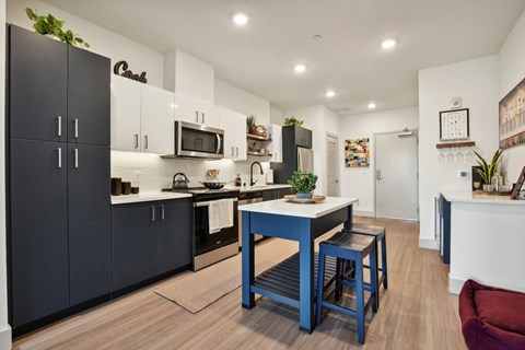 A kitchen with a table and chairs in the middle of it.