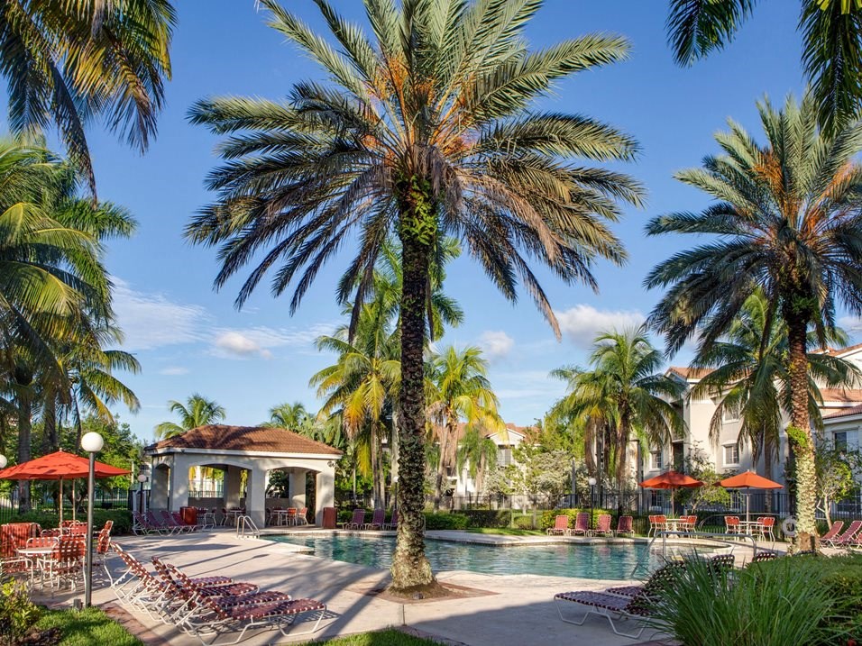 Pool with lounge chairs at Banyan Pointe, Coconut Creek, Florida 