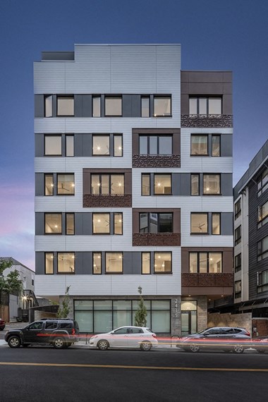 Oakland Apartments - Electric Lofts - Exterior of Building with White Paneling, Windows, and Modern Design