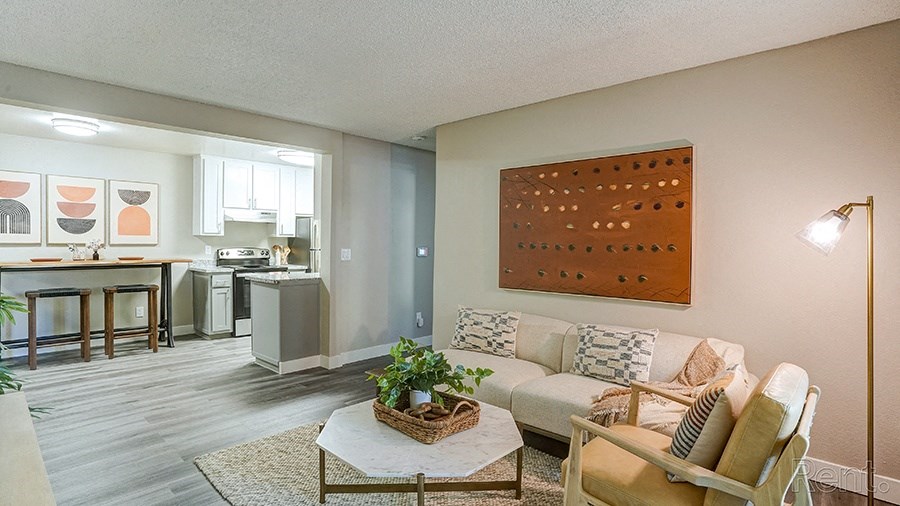 Apartments in Hayward for Rent - Austin Commons - Living Room with Neutral Furniture, Quartz Coffee Table, and Standing Lamp
