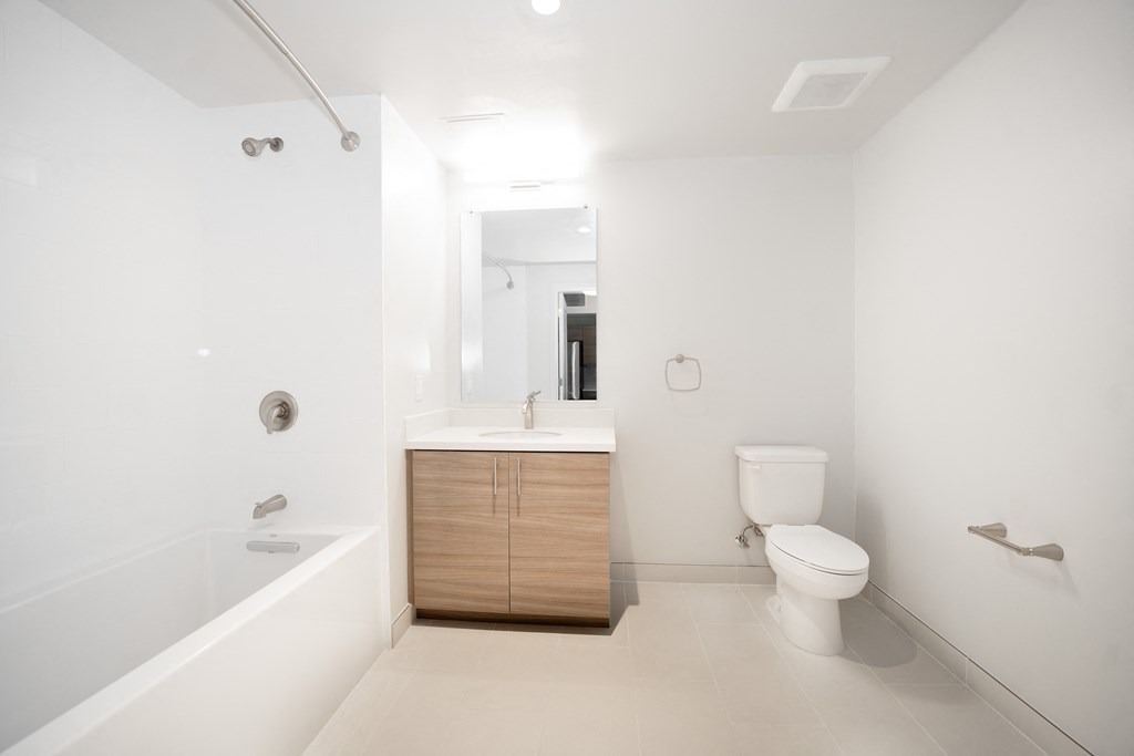 a bathroom with a toilet and a sink and a bath tub