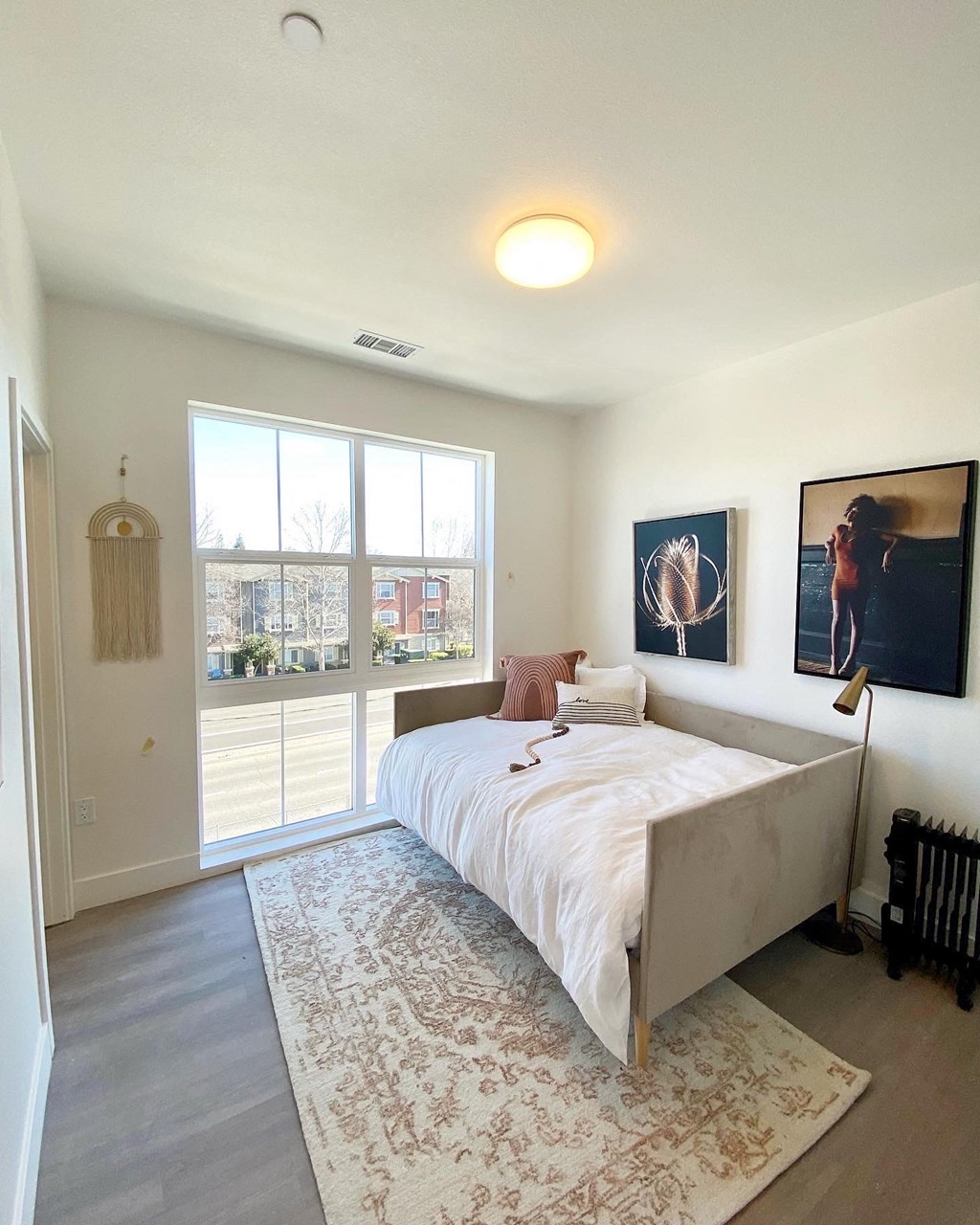 a bedroom with a bed and a large window