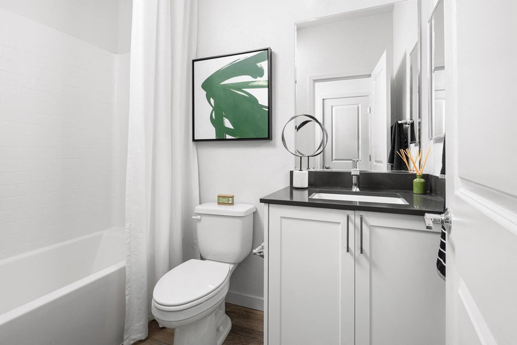 a bathroom with a toilet sink and bathtub in a 555 waverly unit