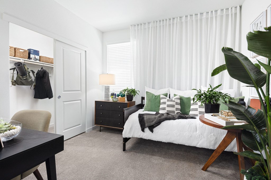 a bedroom with white walls and white curtains