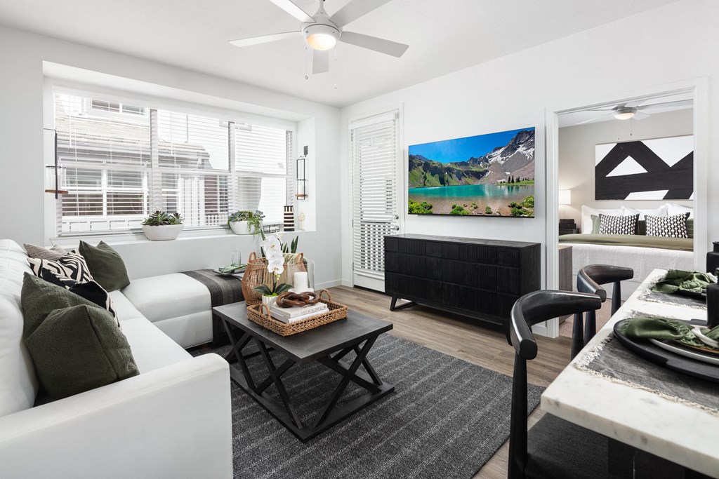 Apartments in Roseville for Rent - Solstice at Fiddyment - Living Room with White Couch, Black Wooden Coffee Table, and Black Media Console