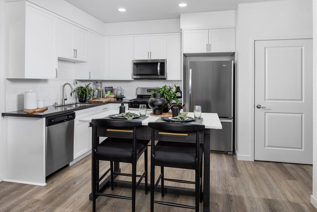 a kitchen with a center island with two stools