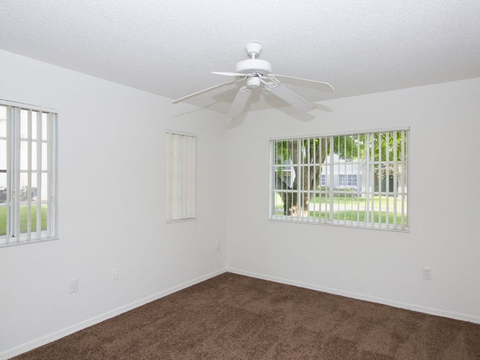 Bedroom with carpet and window at Banyan Pointe, Coconut Creek, 33073