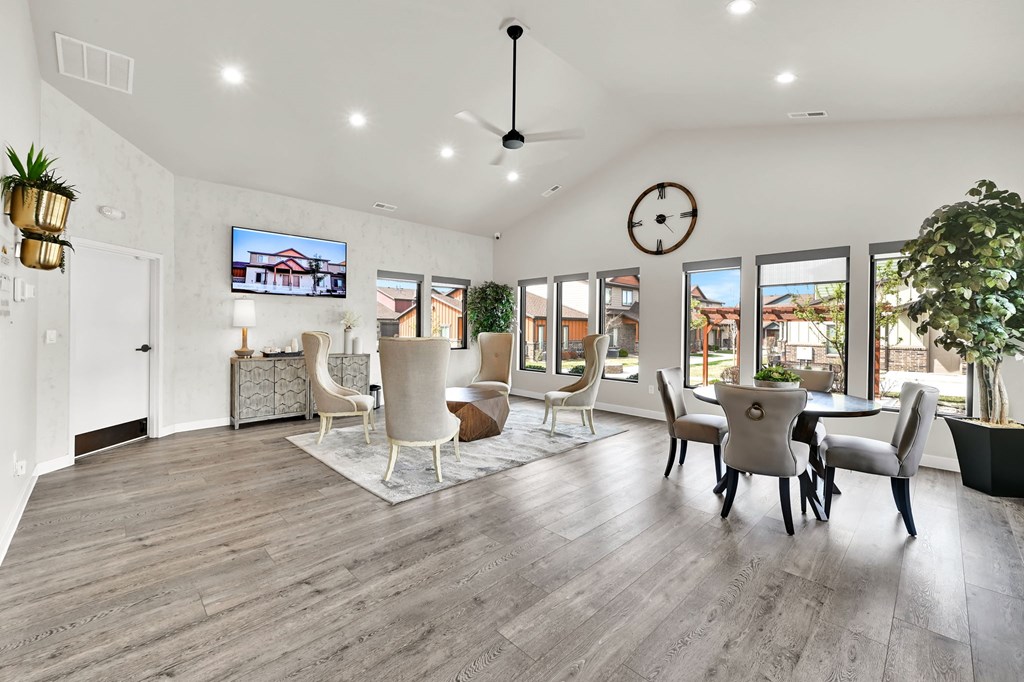 A modern living room with a flat screen TV mounted on the wall.