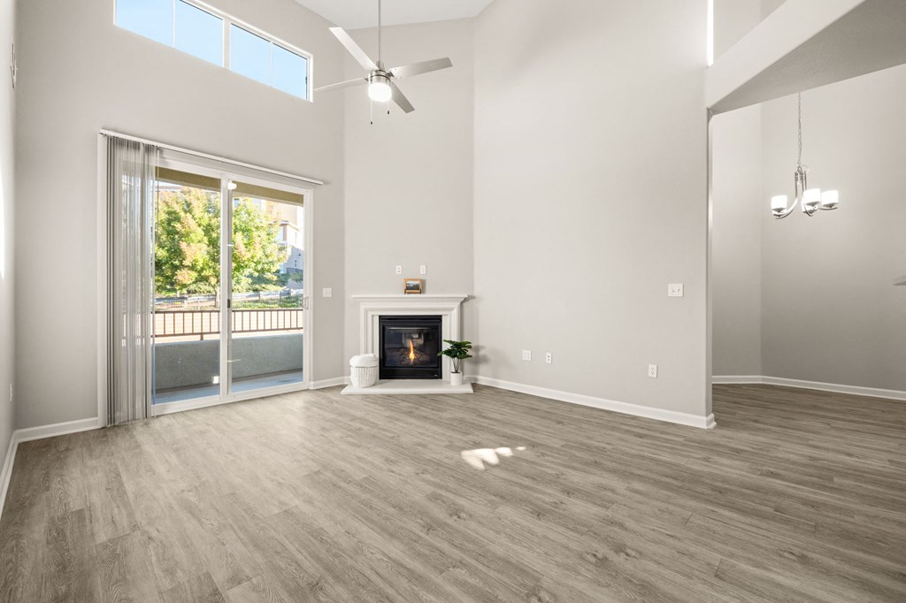 a living room with a fireplace and a sliding glass door