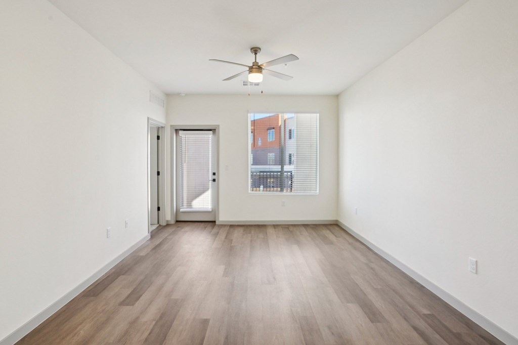 A room with a ceiling fan and wooden flooring.at Cottonwood Ranch, Casa Grande, AZ 85122