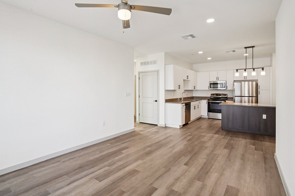 A spacious kitchen with a fan and wooden flooring.at Cottonwood Ranch, Casa Grande, 85122