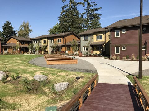 A residential area with houses and a wooden walkway.