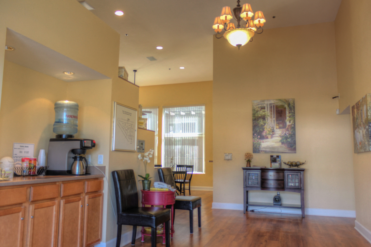 A kitchen with a wooden counter and a coffee maker.